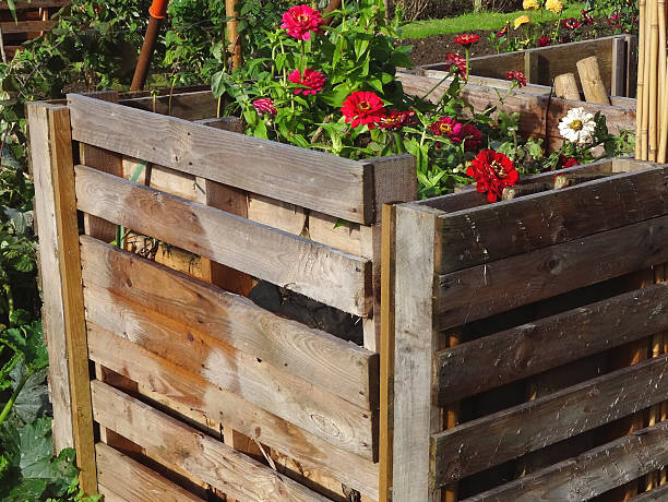 istock Wooden compost heaps, compost bin converters, allotment / vegetable garden waste 519473645