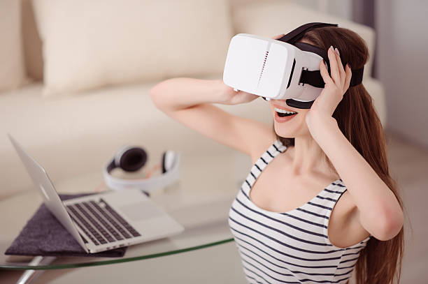 istock Overjoyed girl wearing virtual reality device 519475132