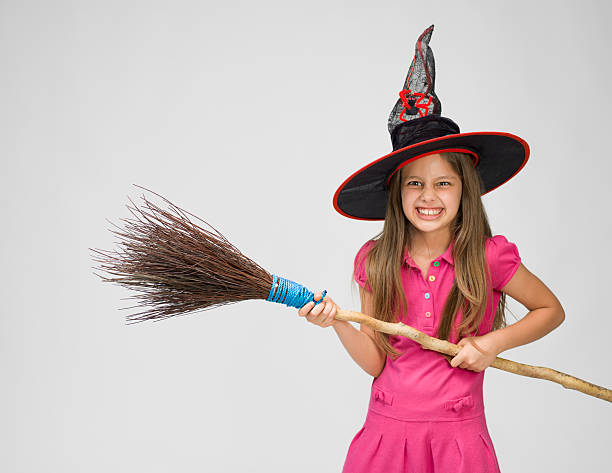 istock Little girl with witch's hat and real broom 519475517