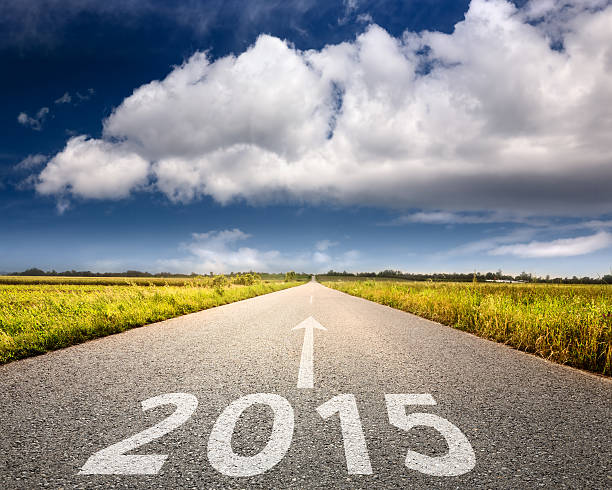 Driving on an empty road towards the big cloud to upcoming 2015