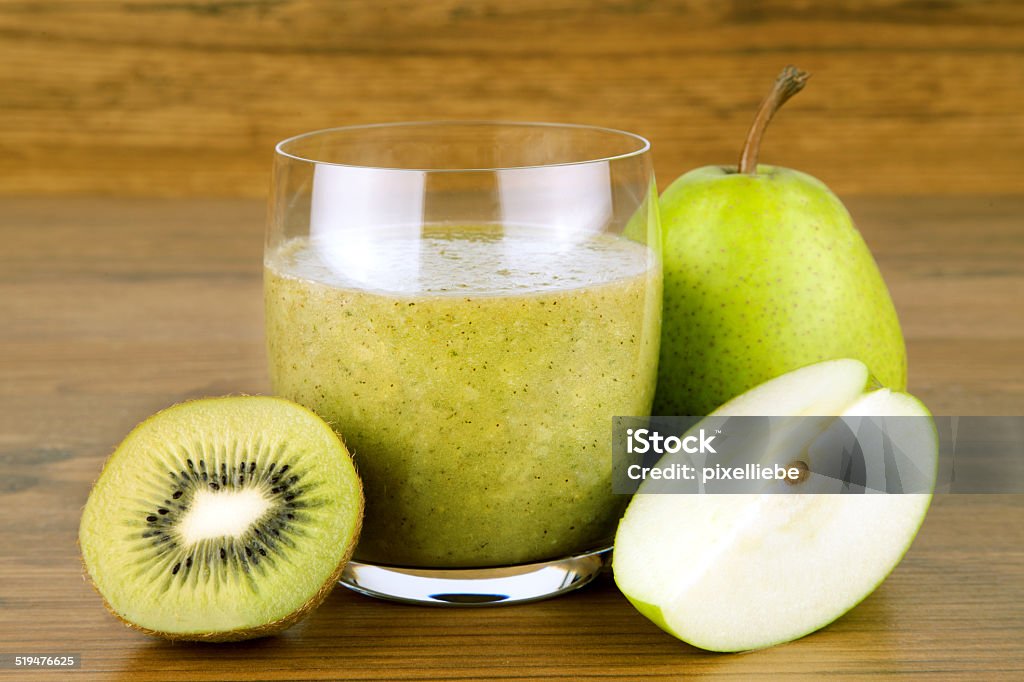 Smoothie green Smoothie against a wooden background with kiwi, pear and apple Kiwi Fruit Stock Photo