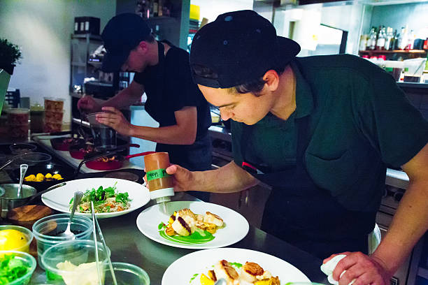 Chef putting finishing touches to his dishes.
