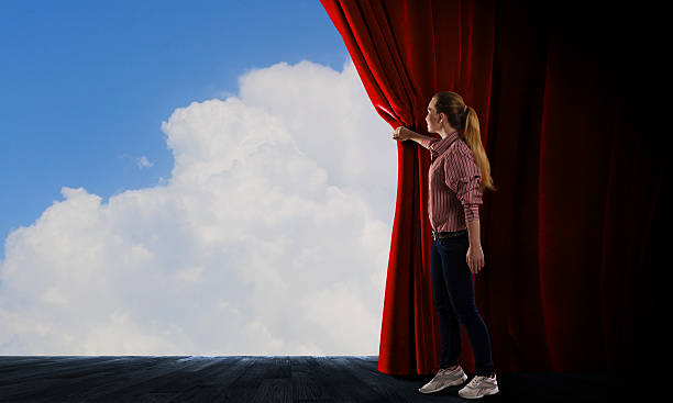 istock Girl opening curtain 519490661