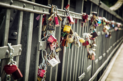 Love locks on the metallic fence. Lovers theme.