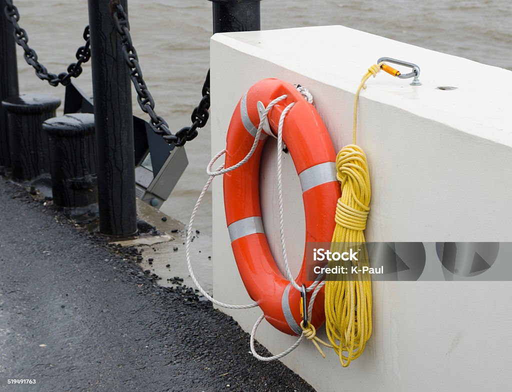 The orange lifebuoy The orange lifebuoy hanging on the wall A Helping Hand Stock Photo