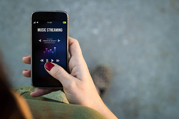 istock Woman walking smartphone with music streaminginterface 519491802