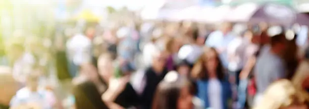 An exterior street scene with a crowd of blurred people. Urban background.