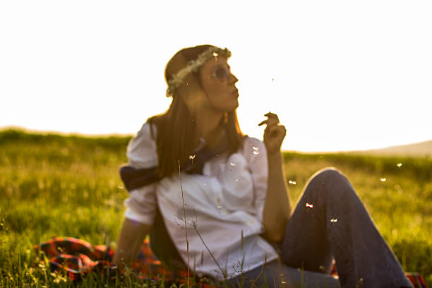 istock Hippie Girl Blowing Dandelion 519492444