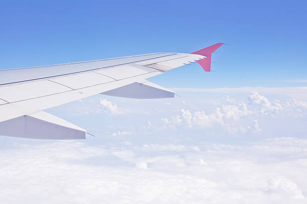 istock Wing aircraft against a background of blue sky and clouds 519493316