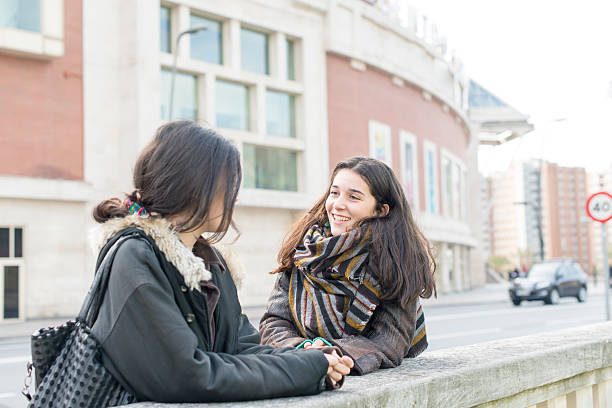 istock Two laughing woman friend talking. 519493472