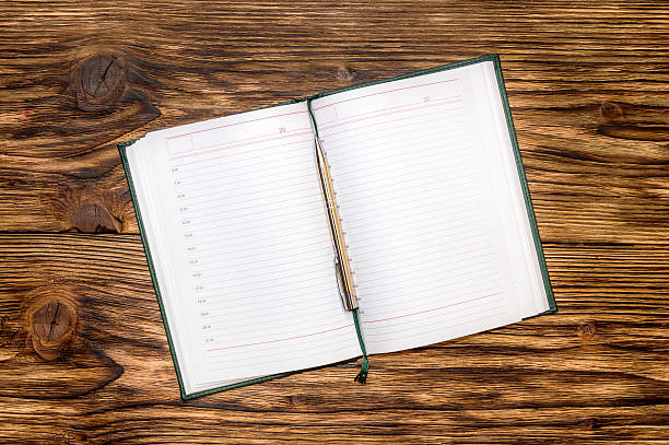 istock Notepad with pen on wooden table. Top View 519493724