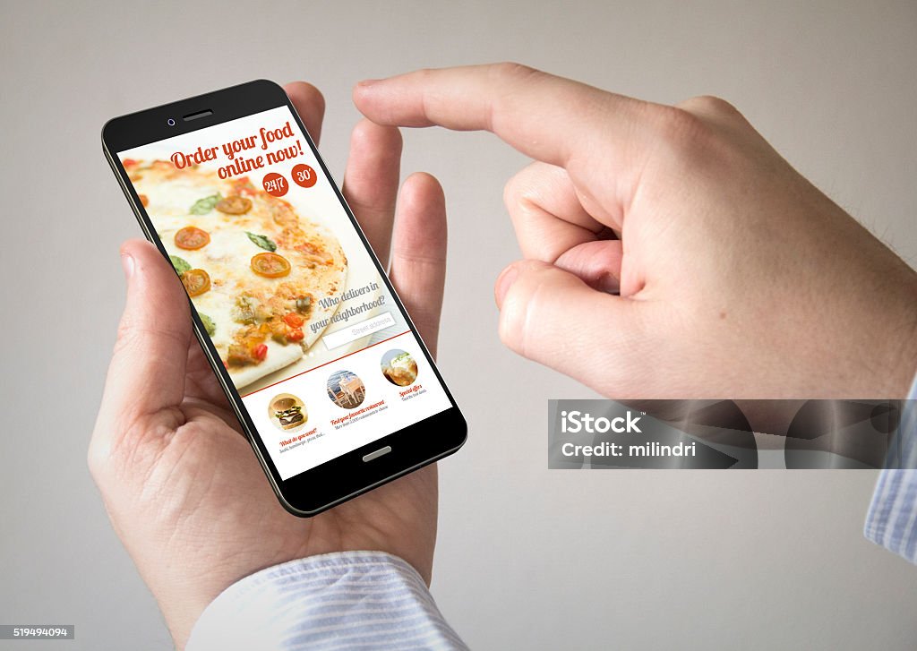 touchscreen smartphone with order food online website on the sc Close up of man using 3d generated mobile smart phone with  order food online website on the screen. Screen graphics are made up. Food Stock Photo