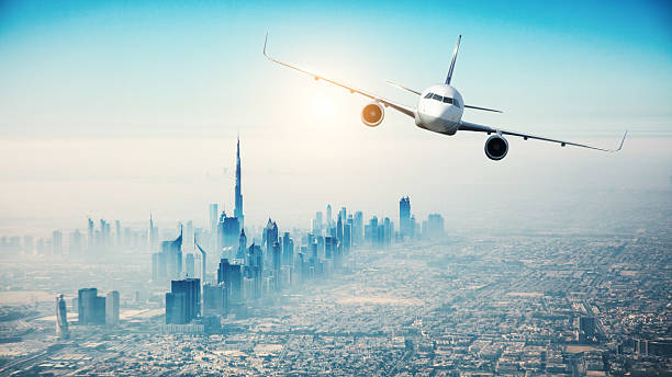 istock Commercial airplane flying over modern city 519494292
