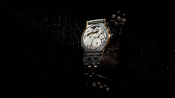 istock Old clock mechanism on a black background 519495470