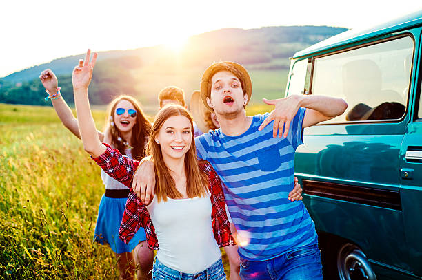 istock Young frieds with campervan, green nature and blue sky 519498668