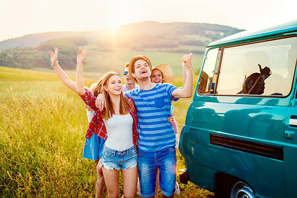 istock Young frieds with campervan, green nature and blue sky 519498738