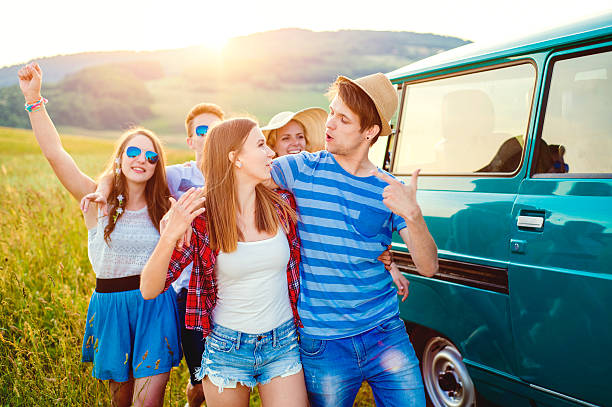 istock Young frieds with campervan, green nature and blue sky 519498814