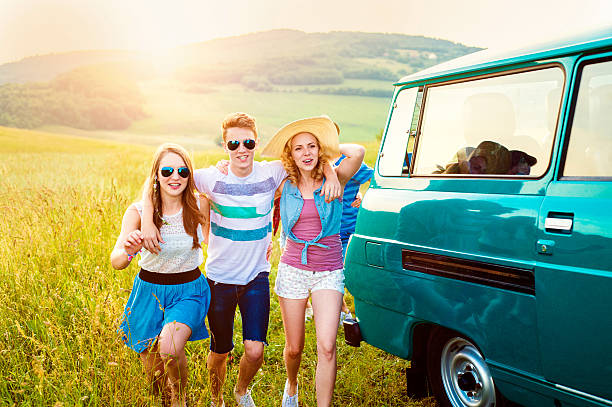 istock Young frieds with campervan, green nature and blue sky 519499064