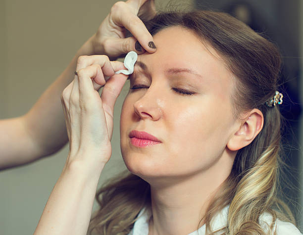 istock Make-up artist cleaning skin on model's face. 519499850