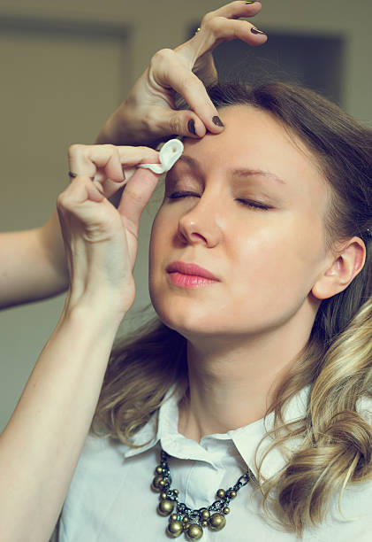 istock Make-up artist cleaning skin on model's face. 519499906