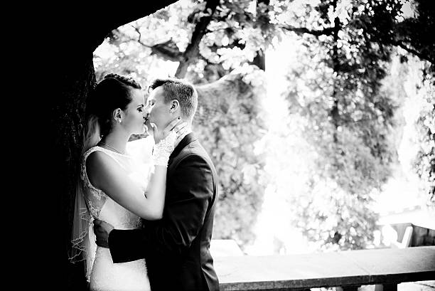 istock Newlyweds kissing under the tree 519500778
