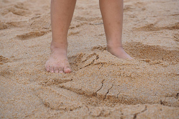 istock Children playing bare feet on the sand on the beach 519504822