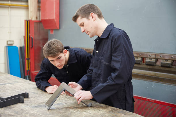 istock Apprentice watching demonstration by engineer in steel fabrication factory 519505252