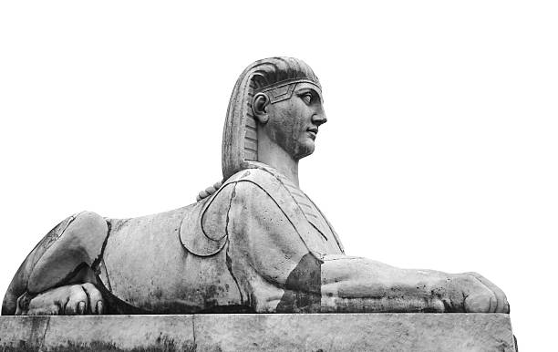 figure statue of a sphinx in an outdoor cemetery park with natural light.