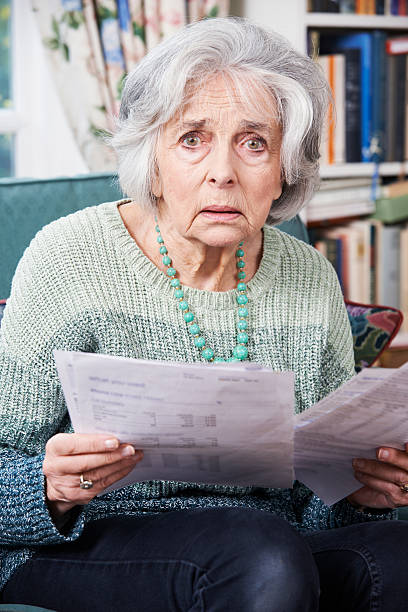 istock Senior Woman Going Through Bills And Looking Worried 519508421