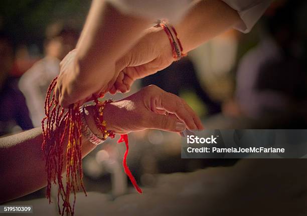 Indian Woman Receiving Sacred Thread Bracelet At Diwali Festival Stock Photo - Download Image Now