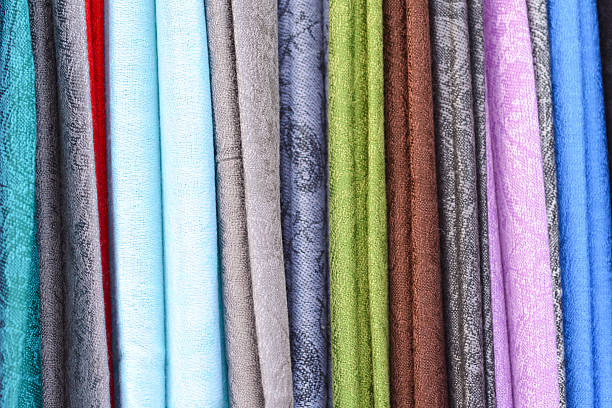 istock Offcuts of Brightly Coloured Fabric Hanging Vertically 519510665