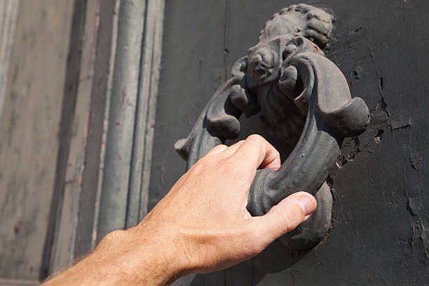 istock Knocking old black door with metal ring knocker 519518216