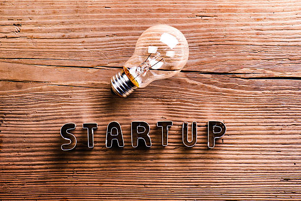 istock Office desk with start up sign and light bulb. 519518478