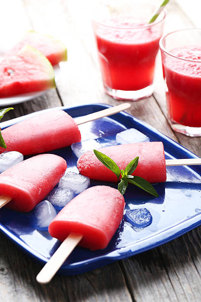istock Watermelon popsicle on tray on grey wooden table 519518672