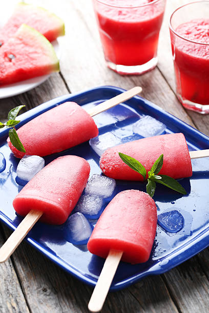 istock Watermelon popsicle on tray on grey wooden table 519518720