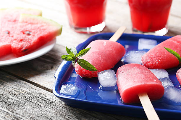 istock Watermelon popsicle on tray on grey wooden table 519518780