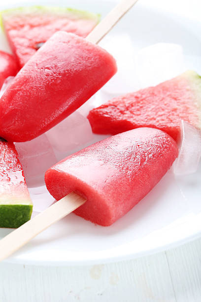 istock Watermelon popsicle on plate on white wooden table 519519058