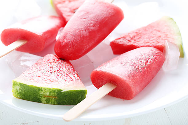 istock Watermelon popsicle on plate on white wooden table 519519156