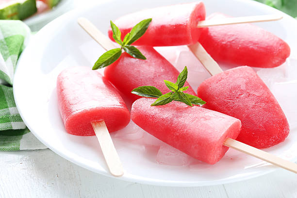 istock Watermelon popsicle on plate on white wooden table 519519422