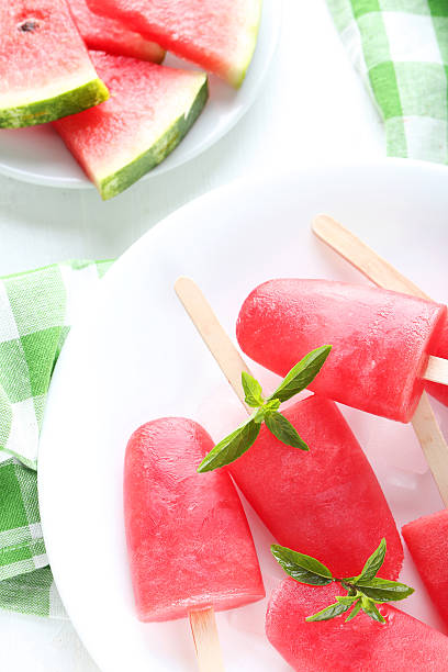 istock Watermelon popsicle on plate on white wooden table 519519628