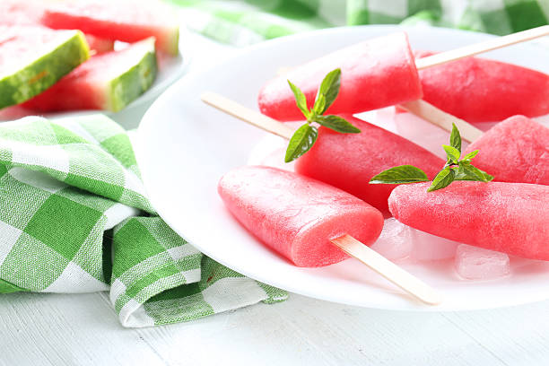 istock Watermelon popsicle on plate on white wooden table 519519682