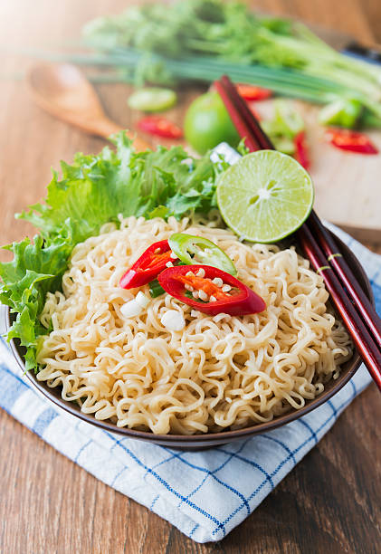 istock chilli on instant noodles in bowl and vegetable background 519519860