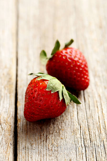 istock Ripe red strawberry on a grey wooden table 519522358