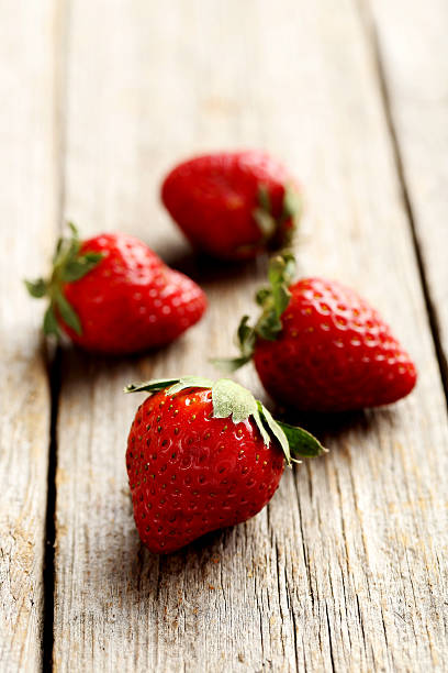 istock Ripe red strawberry on a grey wooden table 519522484
