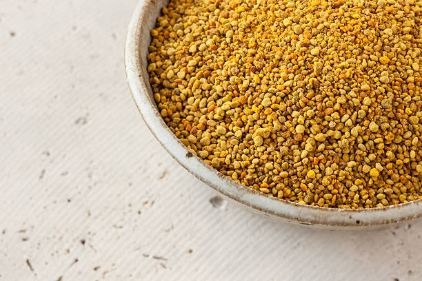 istock Natural bee pollen in ceramic bowl on concrete 519523032