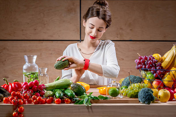 istock Young woman using smart watch in the kitchen 519523438