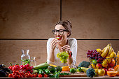 Young woman with fruits and vegetables in the kitchen