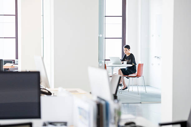 istock Businesswoman using laptop in modern office interior 519524898