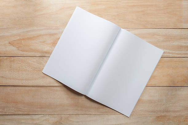 istock Blank paper or book mock up on wood background 519525756