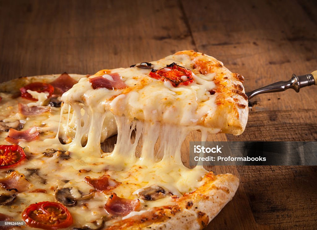 Slice of hot pizza A slice of hot pizza just from the oven with melted cheese dripping Pizza Stock Photo